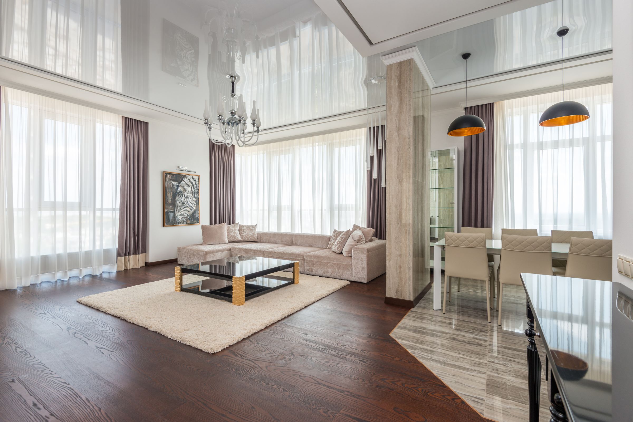 Contemporary villa-style living space with tall windows and elegant furnishings