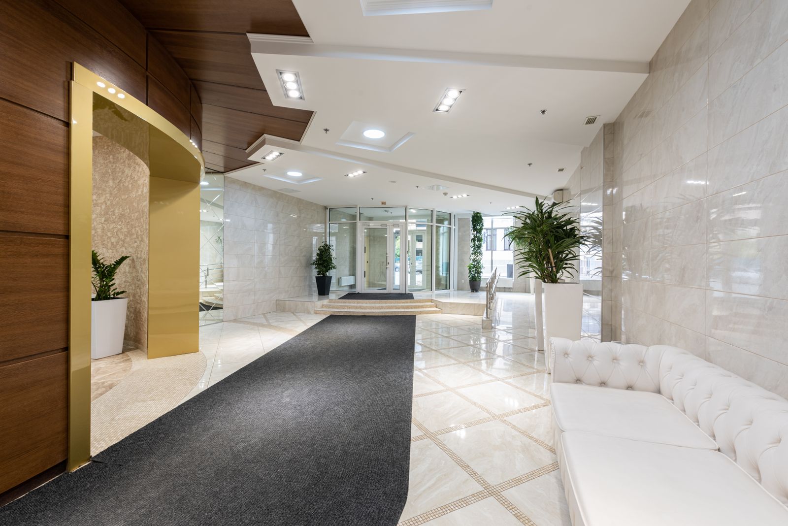 Spacious commercial building lobby with sculptural lighting and lounge seating